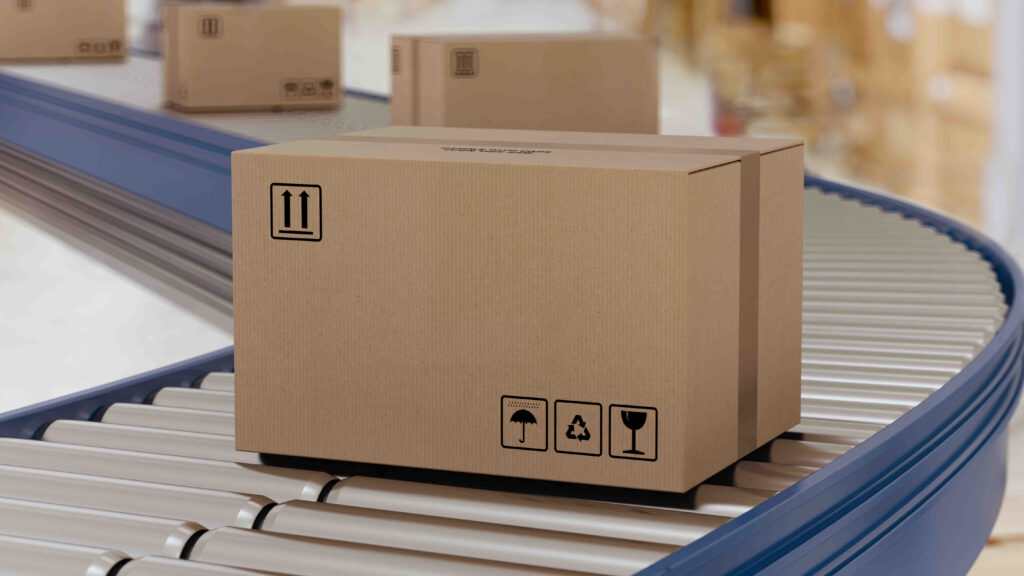 A closed cardboard box moving on a conveyor belt